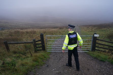 A policeman guards the country astir the excavation tract connected Saddleworth Moor.