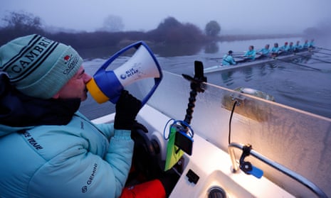 Paddy Ryan, the women’s chief coach, talks through a megaphone to the Cambridge University Boat Club women’s blue boat during a training session on the Great Ouse.