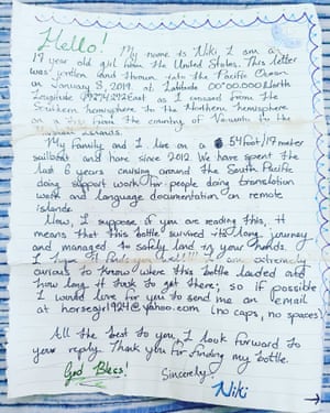 Message in a bottle. A note dropped by American teenager Niki Nie from a sailboat that washed up on a remote Papua New Guinean island.