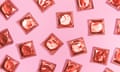 A graphic photo illustration of shiny piny condom wrappers artfully arranged on a solid pink background.