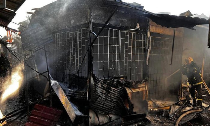 A firefighter puts out a blaze in a market after shelling in Bakhmut, in the Donetsk region