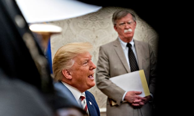 Donald Trump speaks as John Bolton, then his national security adviser, listens in the Oval Office in 2019.