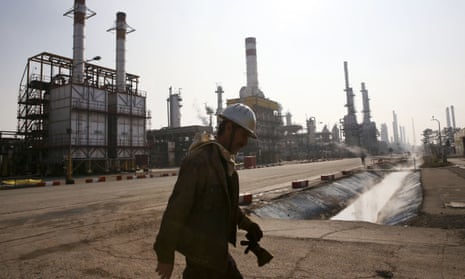 An Iranian oil worker makes his way through an oil refinery south of the capital Tehran.