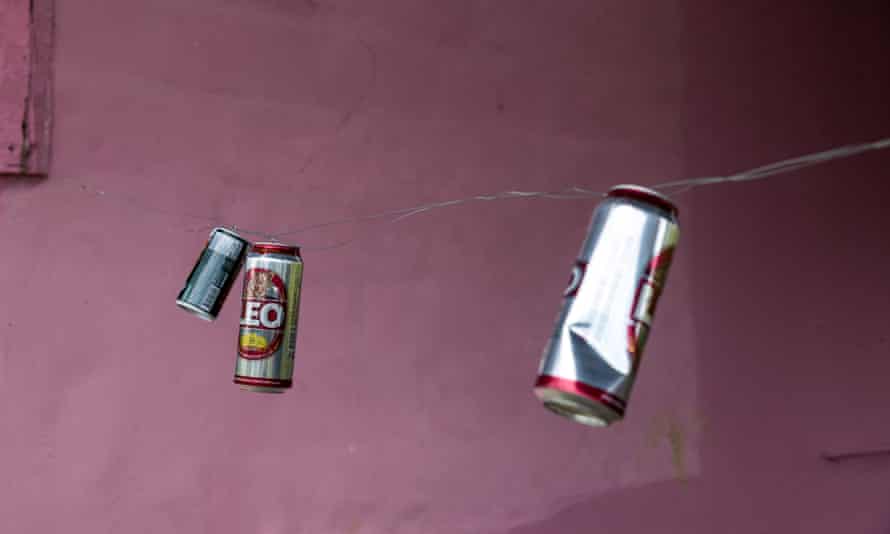 A makeshift protective barrier made from wire and beer cans hangs as a deterrent to wild elephants.