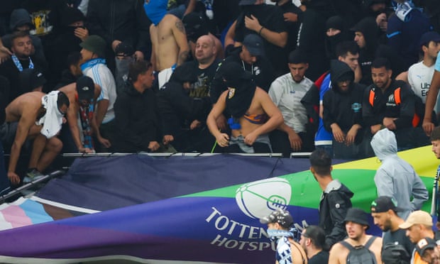 Marseille fans tear a banner supporting Tottenham Hotspur during the UEFA Champions League match in London on 7 September.