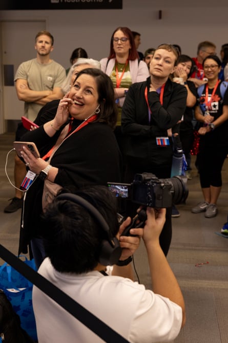 An audience watches a screen in anticipation