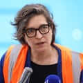 Laure Mériaud speaks into microphones during a press tour of the aquatics centre