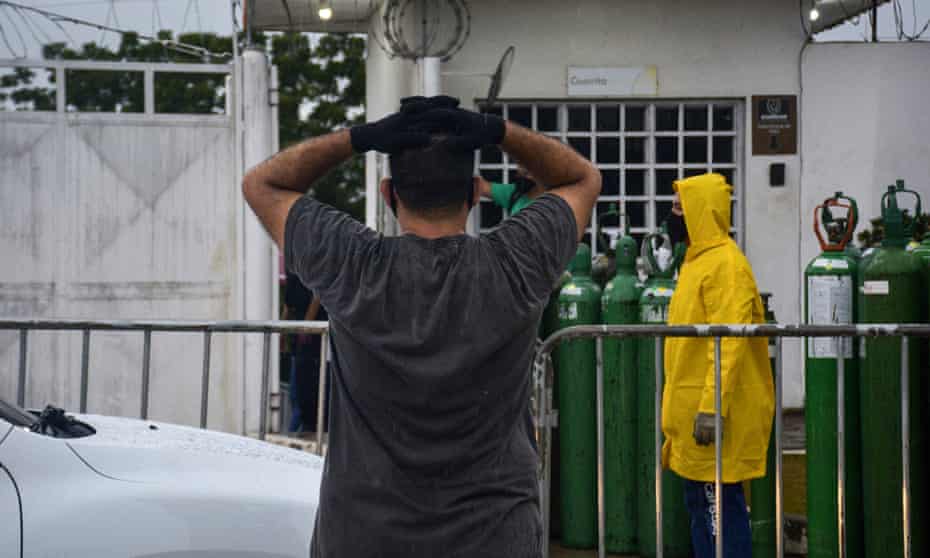 A relative of a patient infected with Covid-19 waits to refill an oxygen tank in Manaus, Amazonas state, on 19 January. 