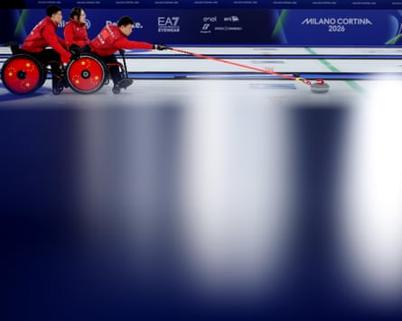 Zhang Mingliang competes with Chen Jianxin and Li Nana in the curling gold medal match