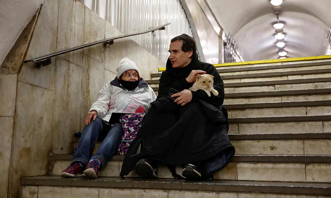 People take shelter inside a metro station