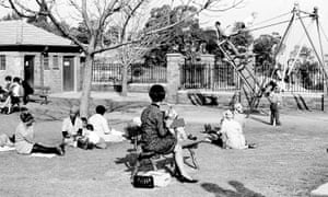 White men and women sit on benches that are “For Whites Only,” while black African women looking after white children sit on the ground at a park in central Johannesburg in 1965.
