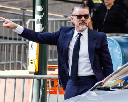 a man in a blue suit and black tie