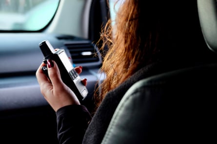 close up of a woman holding a walkie talkie