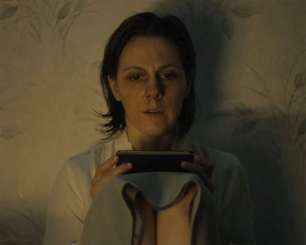 A still from Feels Like Home with the main character examining her phone in the dark