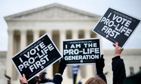 Anti-abortion advocates hold signs as they stand in front of the US supreme court while participating in the 47th annual March For Life in Washington.