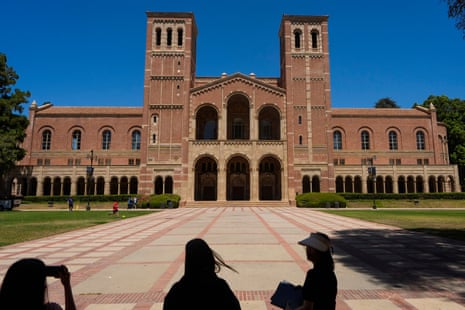 people take pictures on a university campus