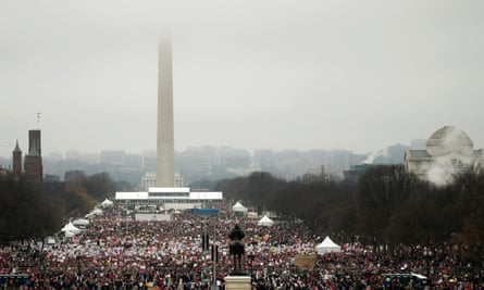 The Washington Monument shrouded in clouds as people pack the National Mall for the Women’s March.