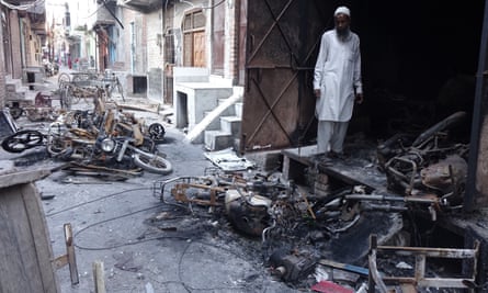 Shops and motorbikes owned by Muslims lie in ruins in Shiv Vihar.