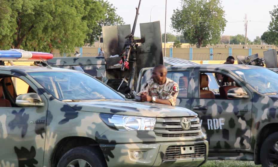 Soldiers block the entrance of the humanitarian group Mercy Corps’ office in Maiduguri
