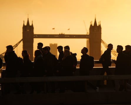 Commuters battle strong winds on London Bridge. London, UK.
