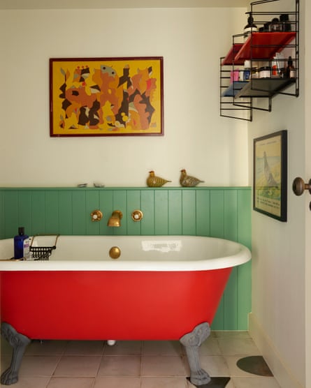 Bathroom, with reddish claw-foot bath successful apartment.