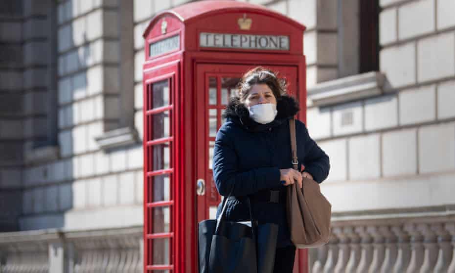 A woman wearing a protective face mask in central London