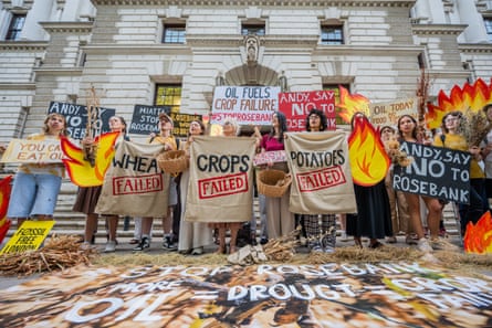 People hold up signs that say: ‘Crops failed’
