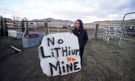 Daranda Hinkey holds a large hand-painted sign that says ‘No lithium, no mine’.