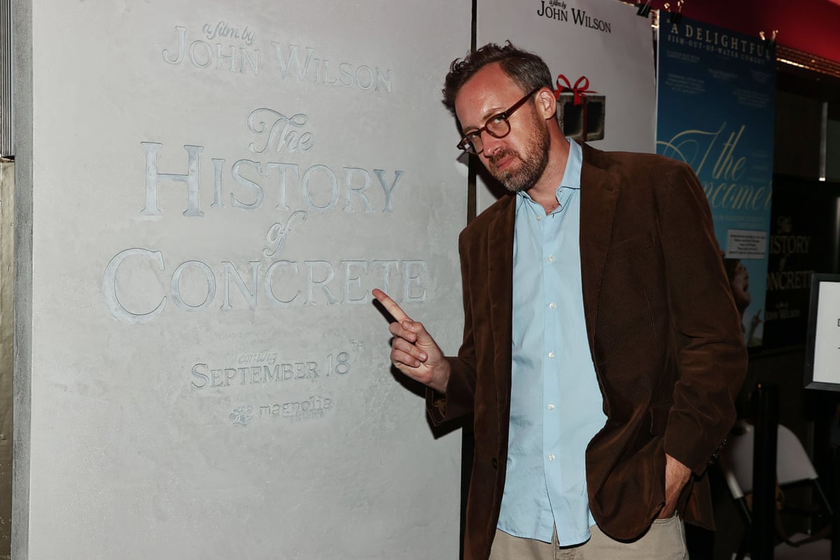 a man in front of a concrete wall