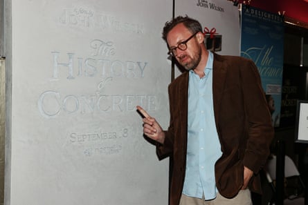 a man in front of a concrete wall