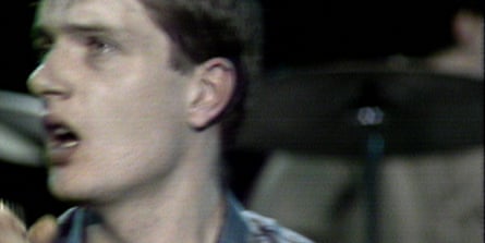 A man in a check shirt with his profile to the camera