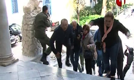 An image grab taken from the Tunisia 1 TV channel shows people escaping from the museum during the attack.