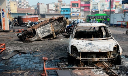 Burnt-out vehicles following clashes in New Delhi