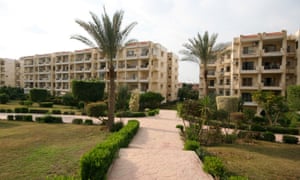 Inside the gated compound Zayed 2000, carefully tended landscaping creates a contrast with the barren ground in public spaces