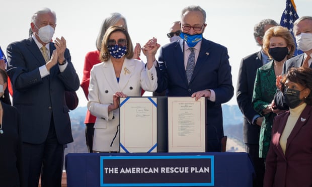 Speaker of the House, Nancy Pelosi, and Senate majority leader, Chuck Schumer, sign the $1.9 trillion Covid-19 relief bill during an enrollment ceremony at the Capitol on Wednesday