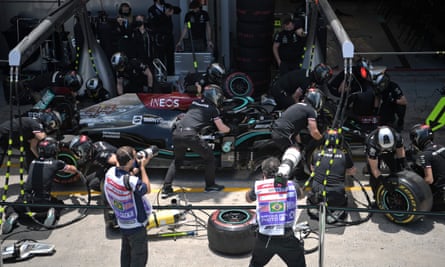 Lewis Hamilton’s pit crew work on his car