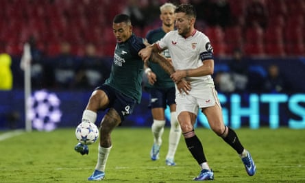 Gabriel Jesus (left) and Ivan Rakitic compete for the ball during the Champions League match between Sevilla and Arsenal.