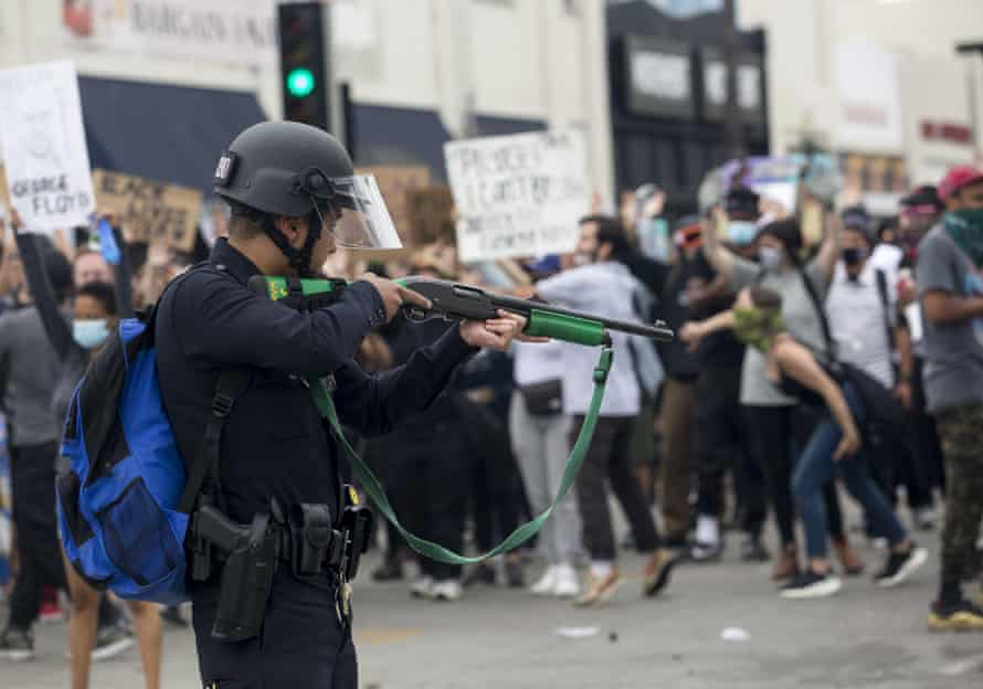 A police officer prepares to fire rubber bullets during a Los Angeles protest on 30 May over the death of George Floyd.