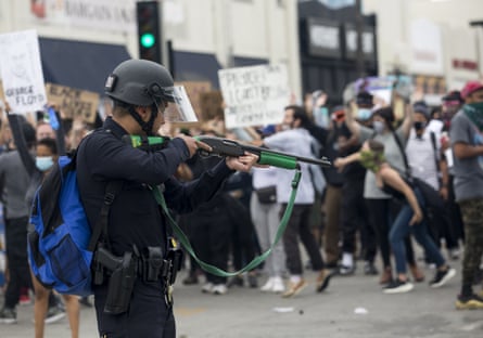 A police officer prepares to fire rubber bullets during a Los Angeles protest on 30 May over the death of George Floyd.