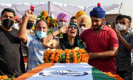 Sandeep Kaur and her brother Prabhjot Singh react after laying the wreaths of flowers on the coffin of their father and soldier Satnam Singh who was was killed in a recent clash with Chinese forces in the Galwan valley area