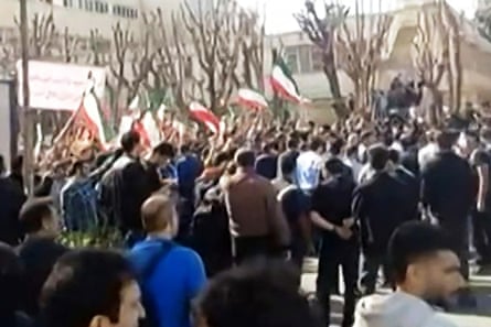 A crowd of people with many holding flags.