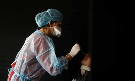 A medical worker performs a rapid Covid-19 antigenic test on a patient in a testing centre in Sautron near Nantes, France.