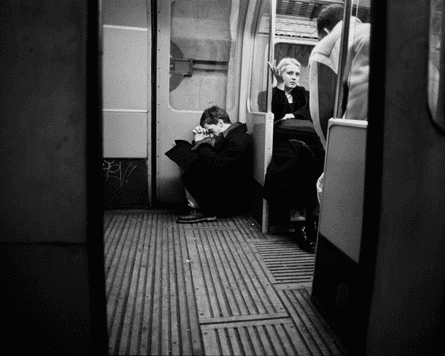 A passenger seeming to pray Piccadilly line