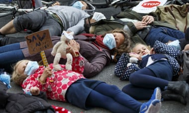 Parents and children stage a die-in protest against pollution in London.