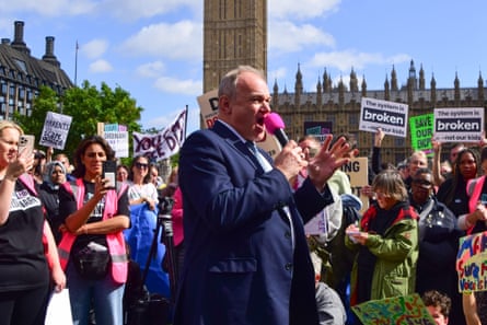 Liberal Democrat party leader Ed Davey speaks to protesters outside parliament on 15 September 2025.