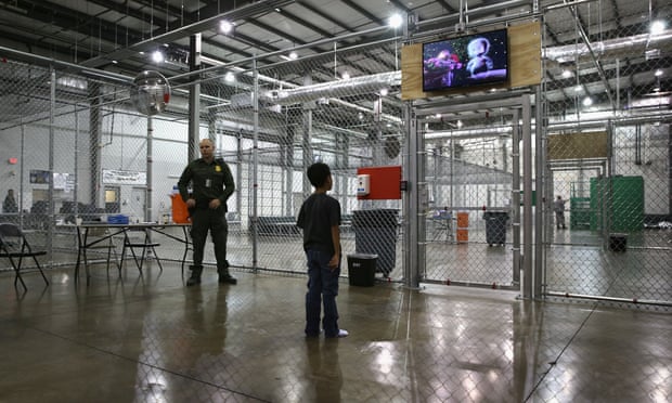 A boy from Honduras watches a movie at a detention facility run by the US border patrol in McAllen, Texas.