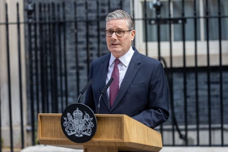 Keir Starmer in suit and glasses at podium outside 10 Downing Street