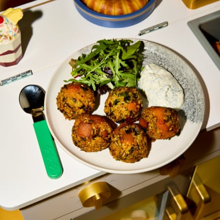 Plate of food with a child's spoon next to it