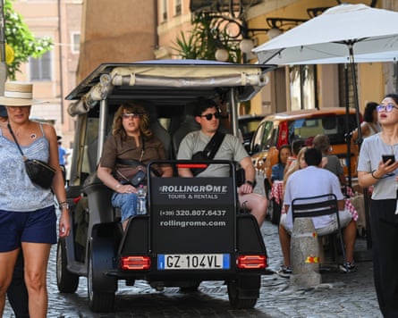 Two people riding in the back of a golf cart