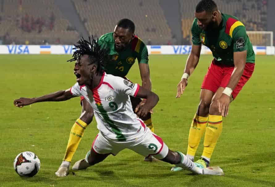 Issa Kabore heads for the turf while playing for Burkina Faso against Cameroon in February at the Africa Cup of Nations.